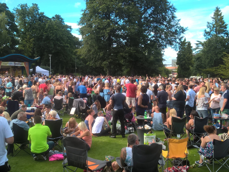 A large gathering of people in Grove House Gardens for a Rock Music Festival