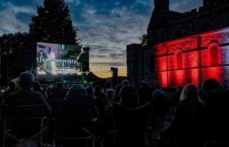The giant video screen at Priory Proms in the Park