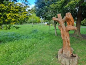 owl sitting on a tree wooden sculpture
