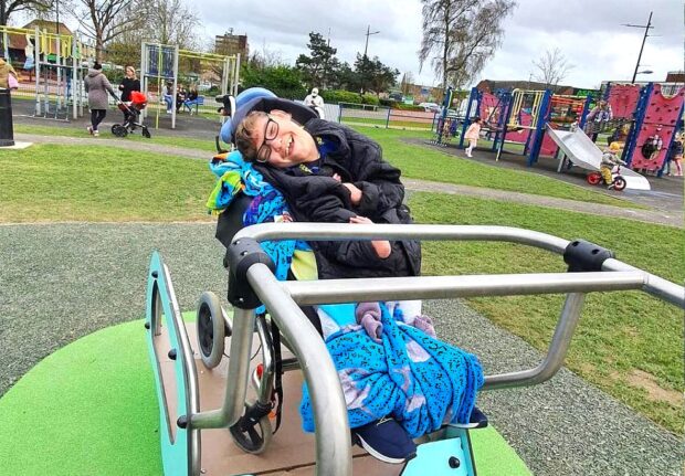 child in wheelchair on the inclusive seasaw