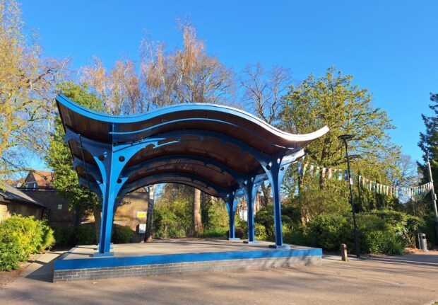 front of the blue performance area bandstand with bunting along side it