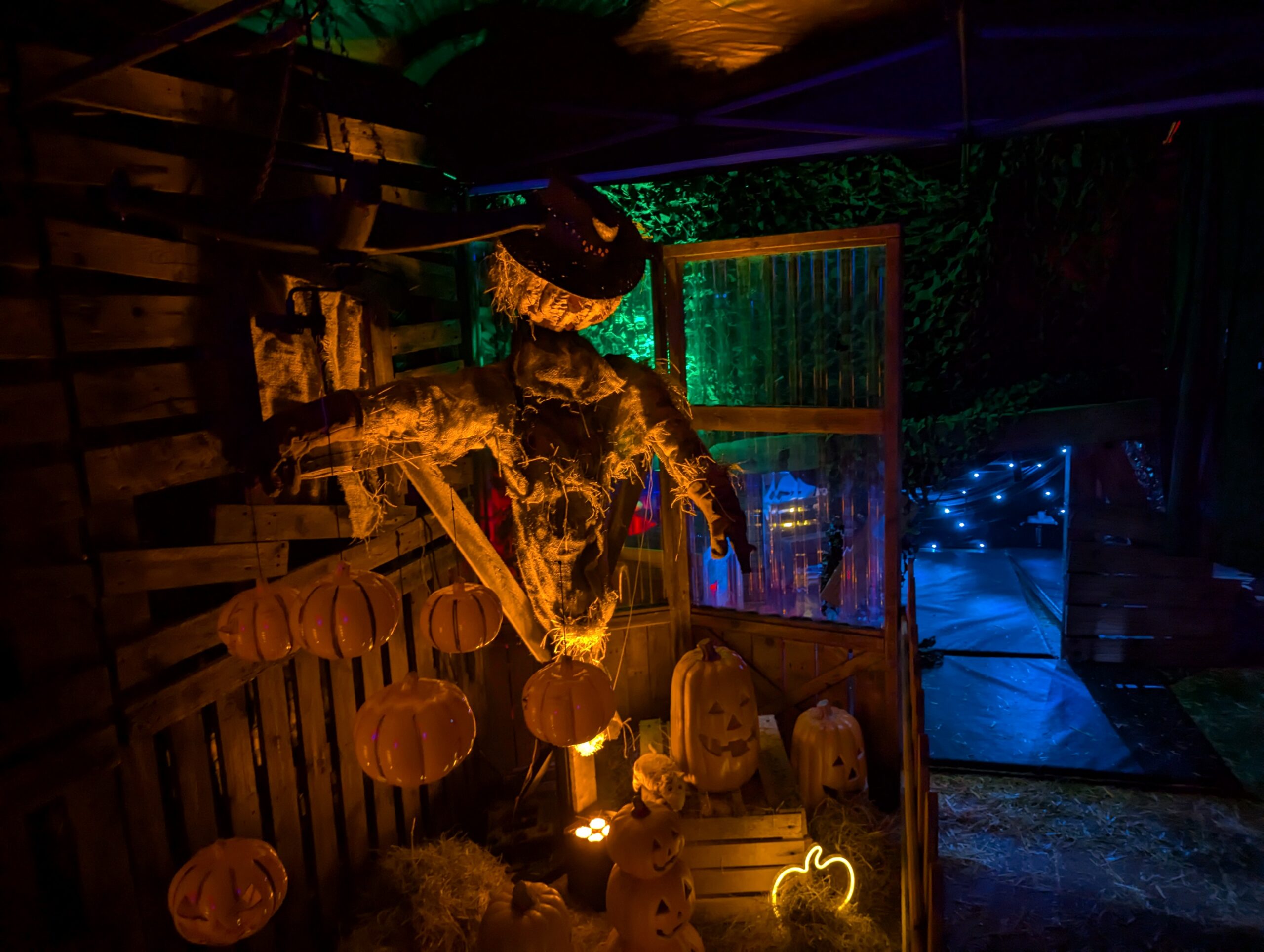 Skeleton in a dark walk way with blue and green lights