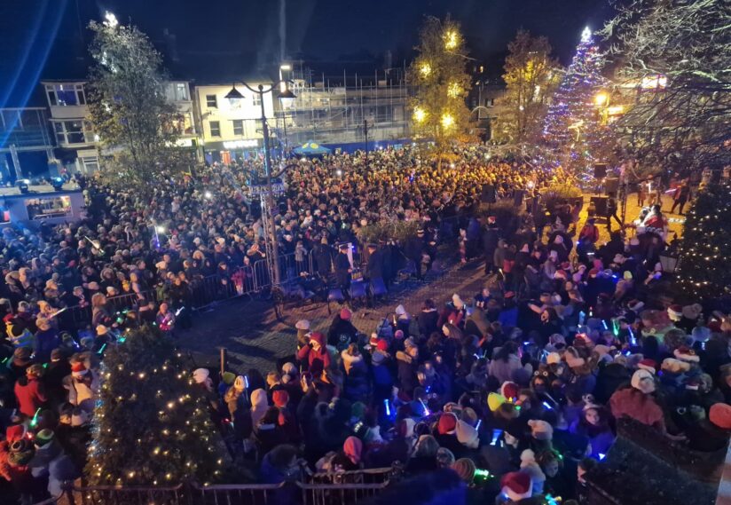 large crowds at the Torchlight event with the church in the background