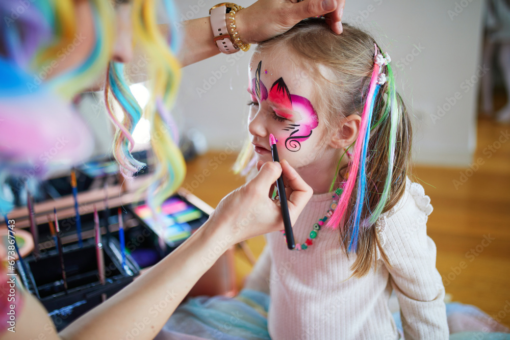 face painting with child at Middle Row Markets
