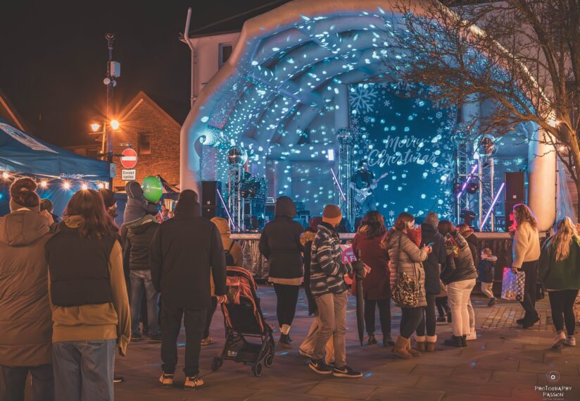Stage at Twilight markets with people watching