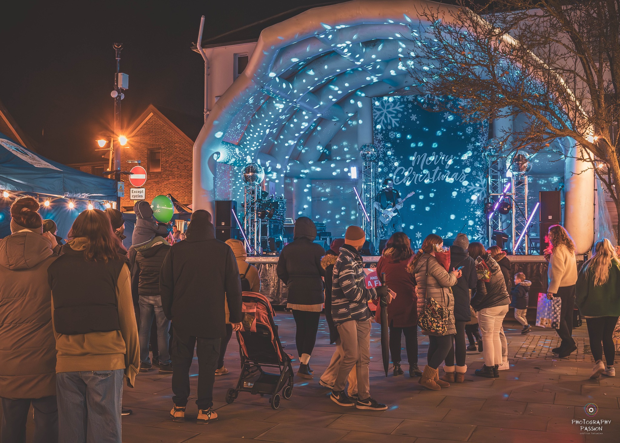 Stage at Twilight markets with people watching