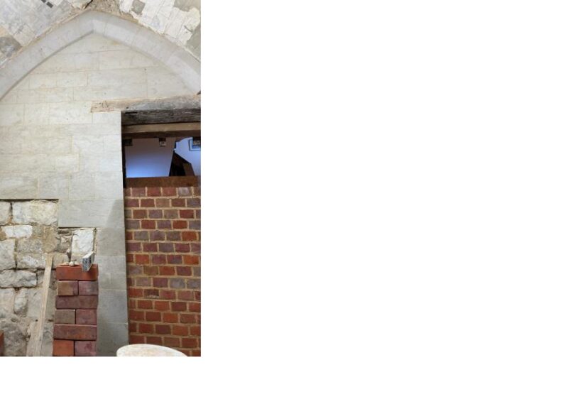 Priory House - Undercroft internal east wall new stonework and brick infill of doorway.