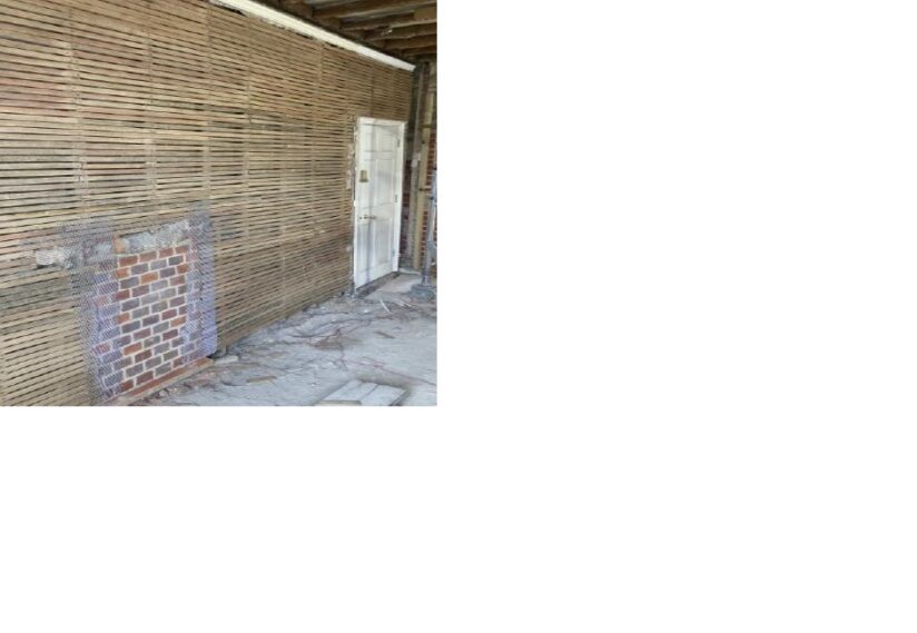 Priory House first floor exhibition room with un-plastered walls and newly bricked in fireplace