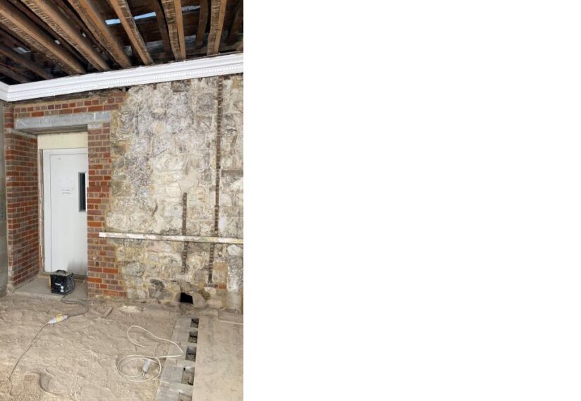 Internal southern wall with door to raised platform. Now with new lintel and brickwork tying in the structure.