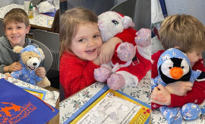 Three children are joyfully hugging stuffed toys: a brown bear, a sparkly Santa, and a penguin, with a festive table in the background.