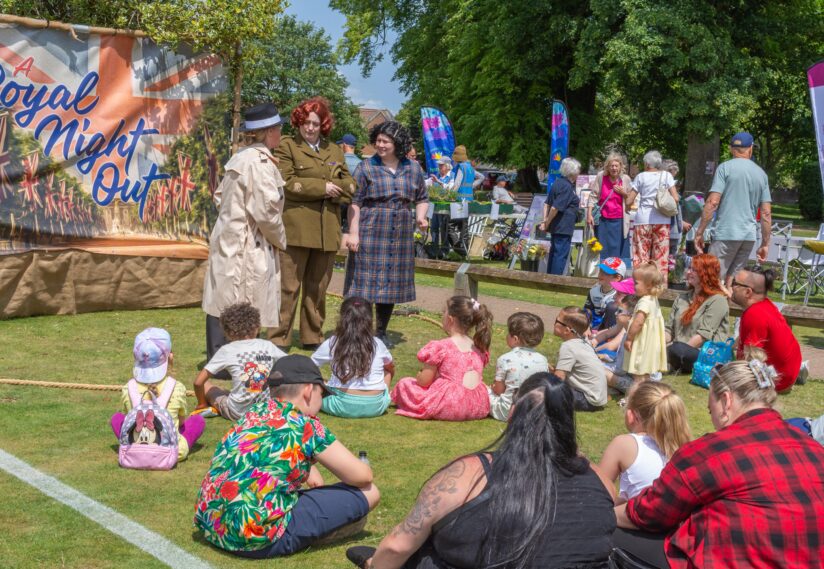 children watching a show in the gardens