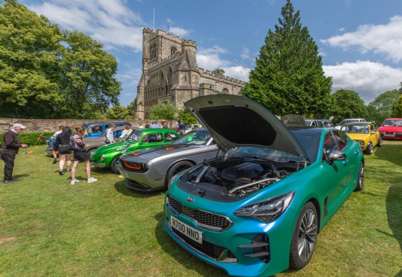 car with open bonnet and cars in the background