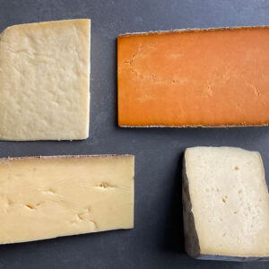 Four cheese slices on a board
