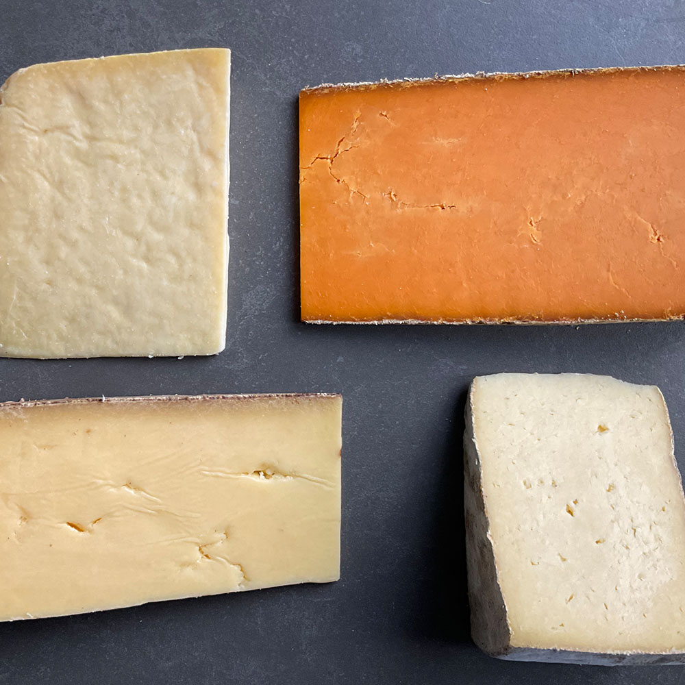 Four cheese slices on a board