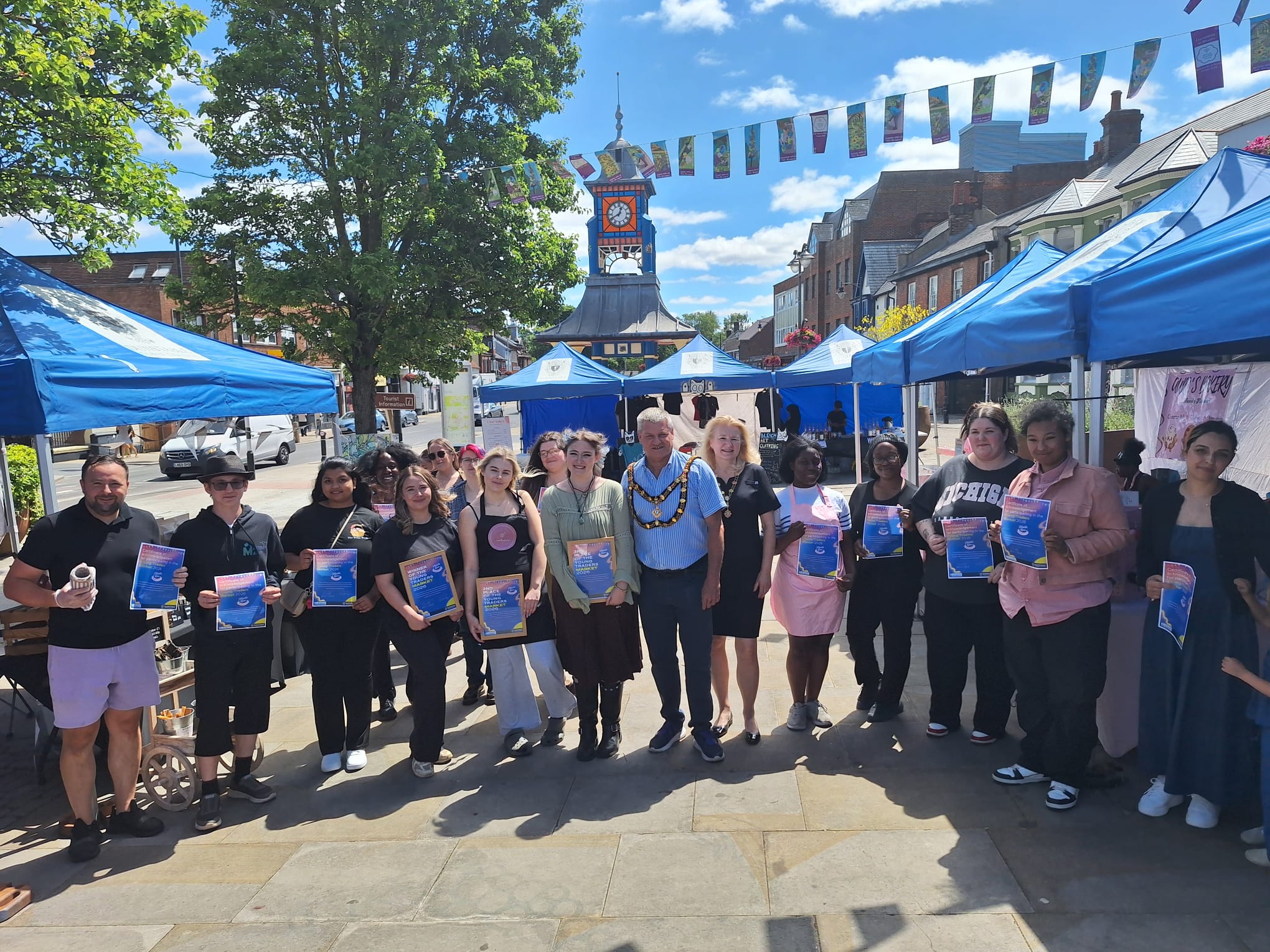 all young traders standing with certificates